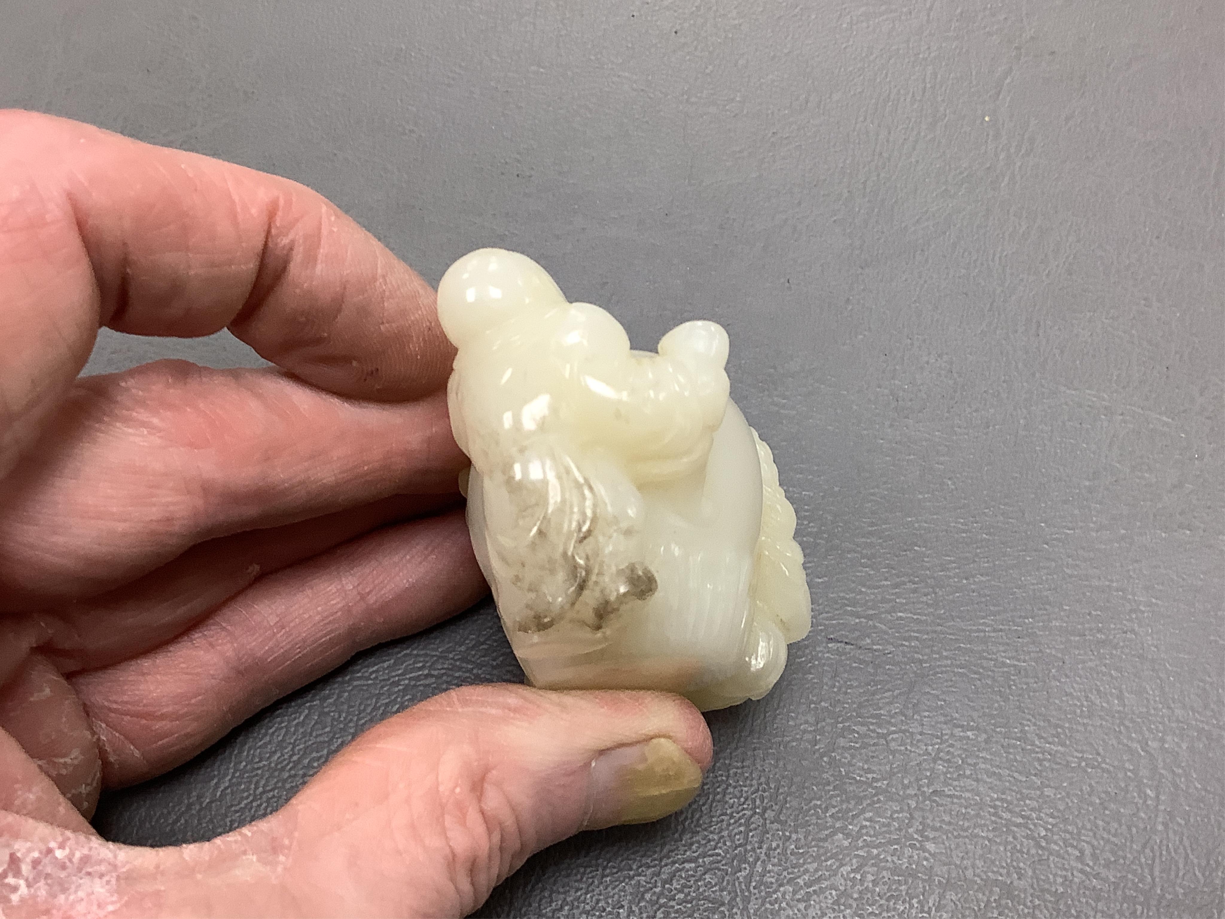 A Chinese white jade 'boys with jar' carving and three shoushan stone figures; luohan, girl with squirrel and mermaid (4), tallest 11cm